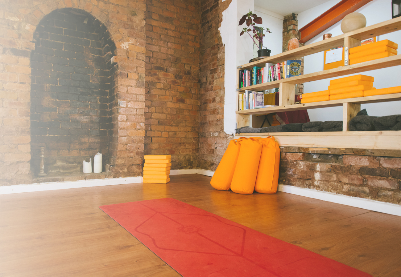 Sandstone Yoga Sutton Coldfield studio with yoga mas and shelving
