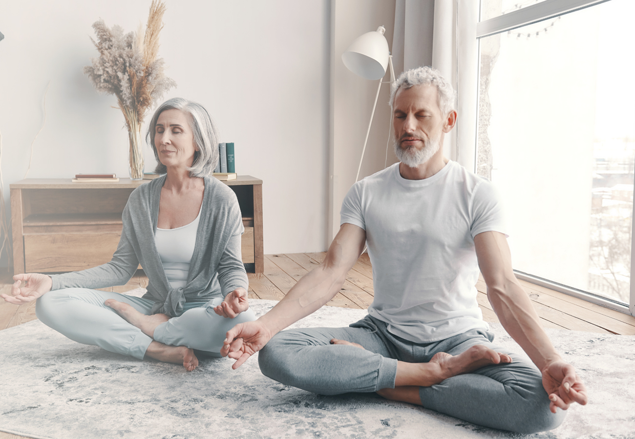 Middle aged couple of man and woman doing pilates and yoga